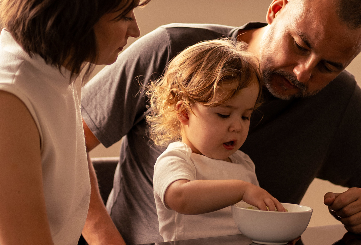 Criança comendo com os pais ensaio fotográfico em familia