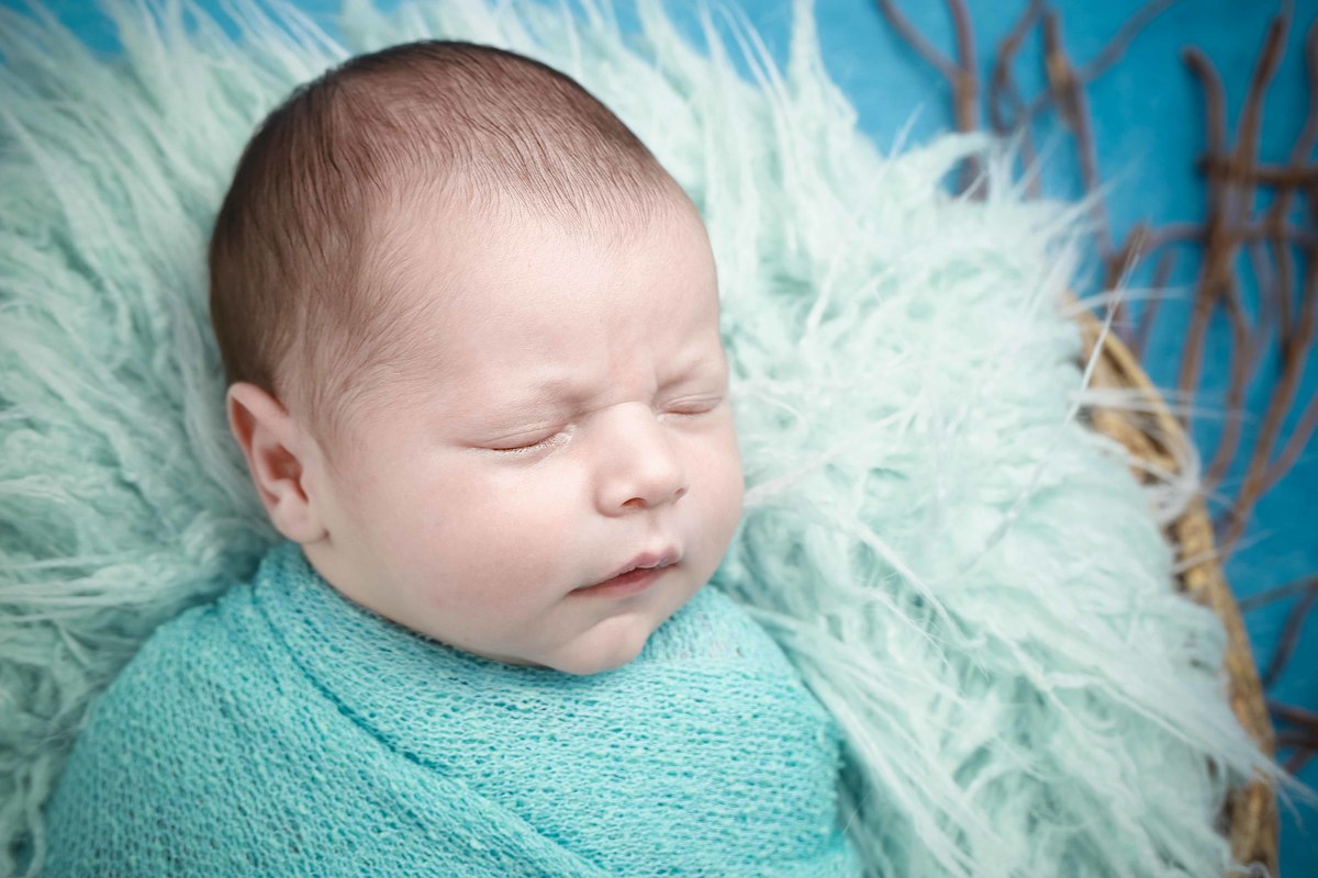 newborn fundo azul cesto menino foto de rosto