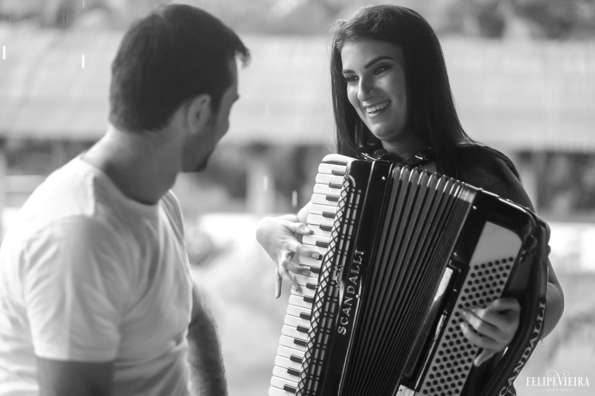 Noiva realizando sonho de tocar sanfona para o noivo durante ensaio feito pelo fotógrafo Felipe Vieira fotografia de casamento