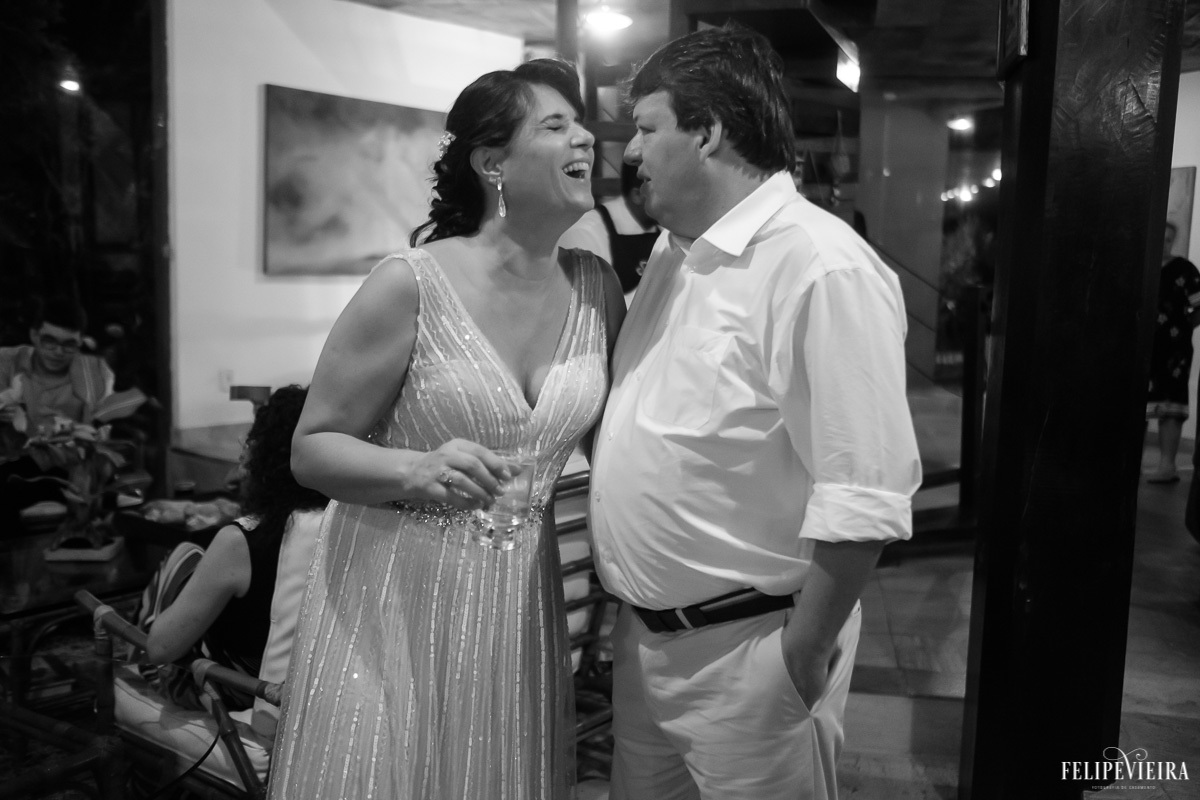 noiva sorrindo enquanto conversa com seu noivo na festa em feita por Felipe Vieira fotografo de casamentos em guarapari e grande vitória