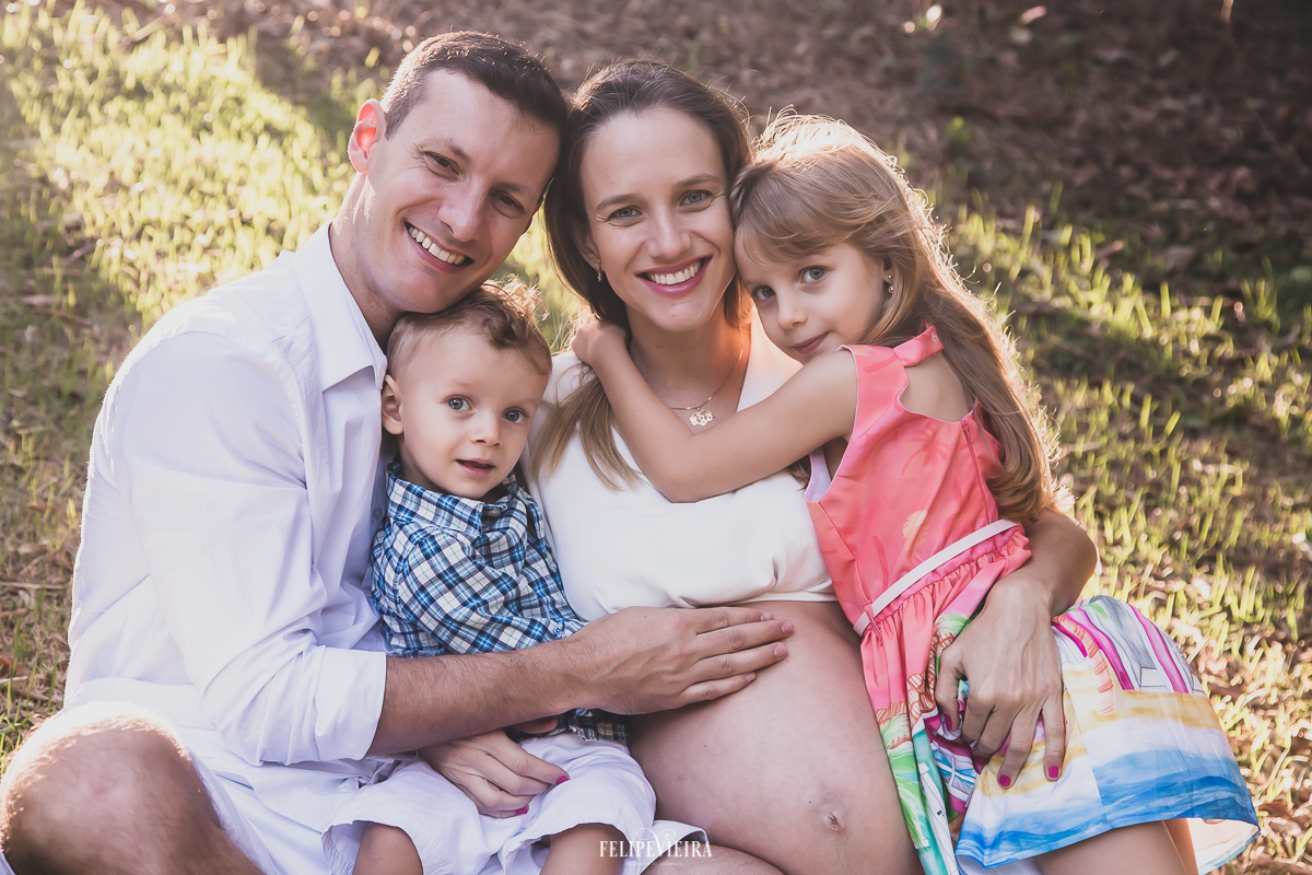 foto de familia na praia dos padres em Guarapari gestante com os filhos e marido com esposa grávida no ensaio fotográfico com 33 semanas de gestação