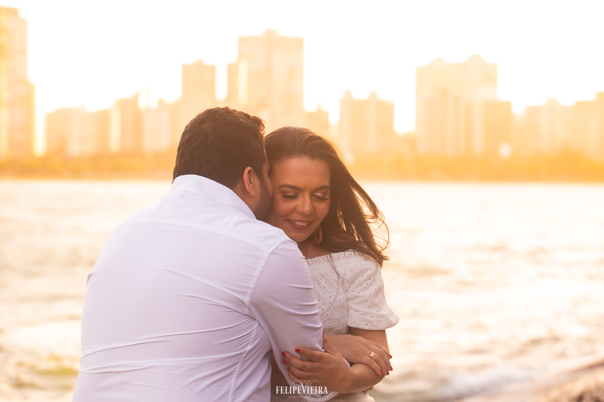 ensaio casal de noivos com a cidade de Vitória como fundo durante por do sol na praia dos namorados em Vitória