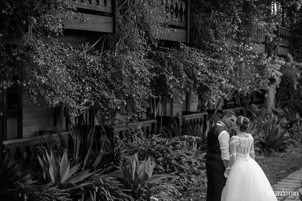 casal na frente de uma parede em preto e branco dos casal de mãos dadas na pousada pedra azul na região serrana fotografia feita pelo fotografo de casamento felipe viera fvfotografo de guarapari