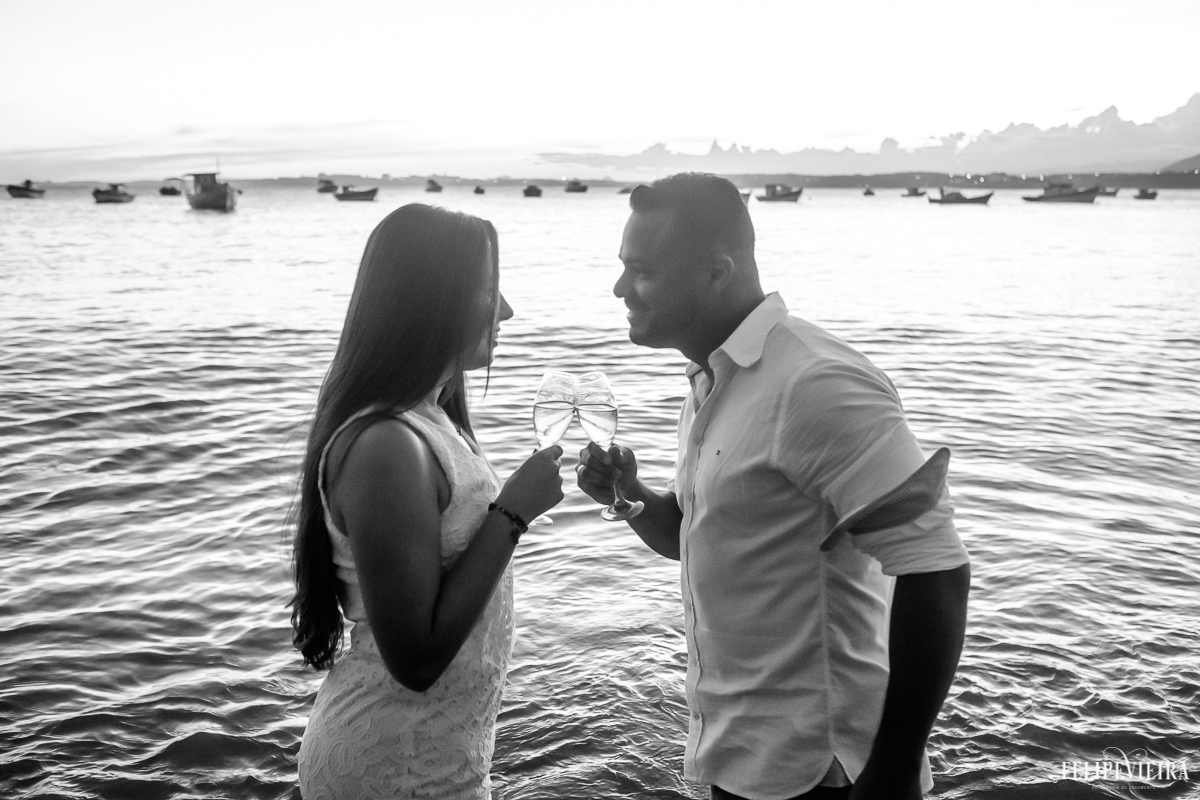 Nana e Edy brindando durante o por do sol finalizando o ensaio pre wedding feito pelo fotografo Felipe Vieira fotografia em Guarapari-ES