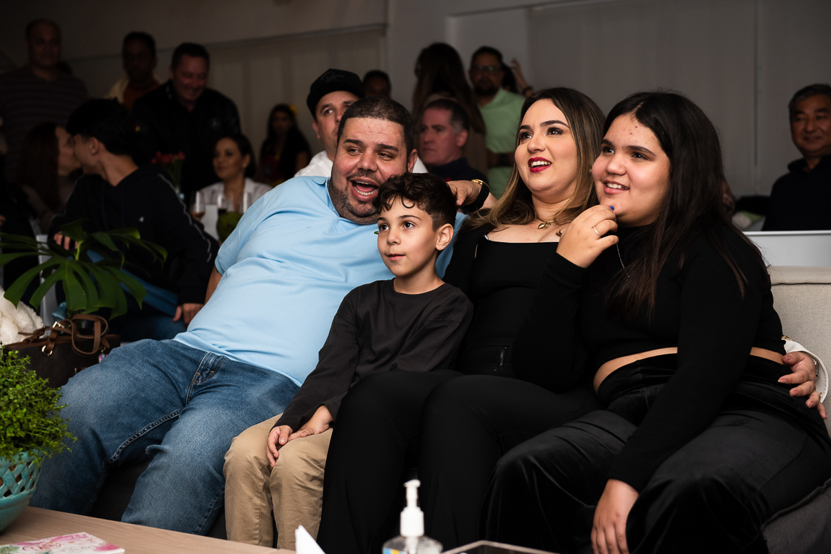 família sentada assistindo a retrospectiva