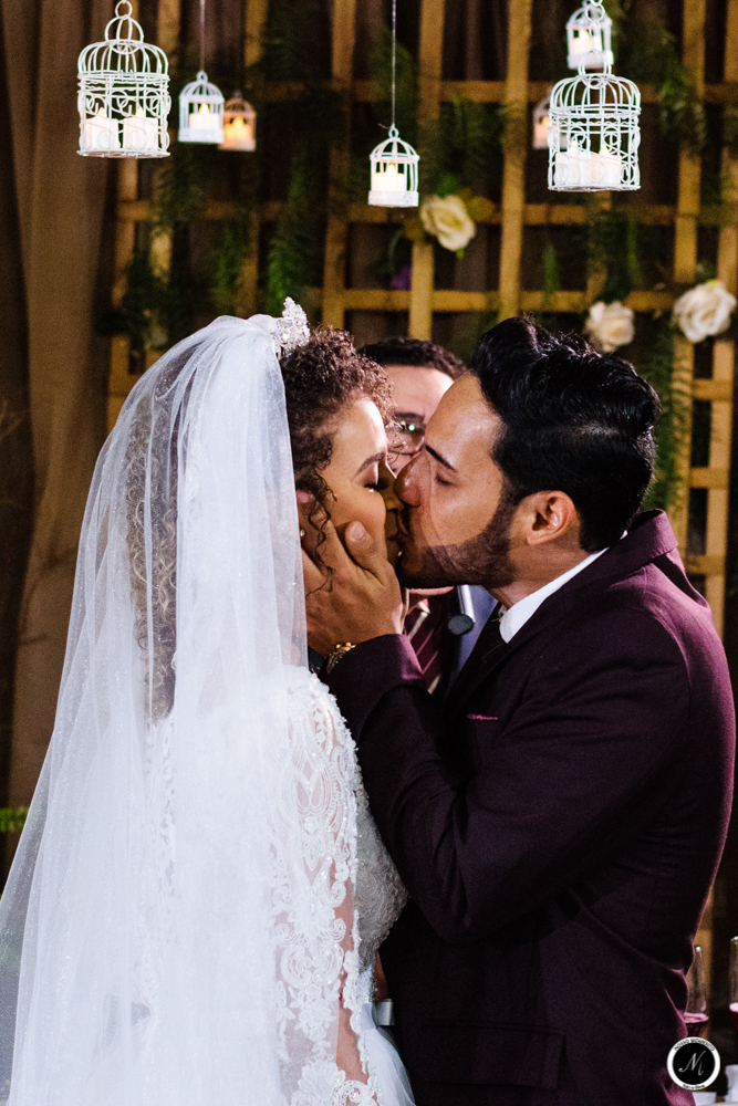 O beijo dos noivos em casamento ao ar livre