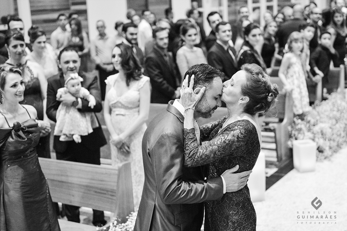 A mãe se despede do noivo com um beijo