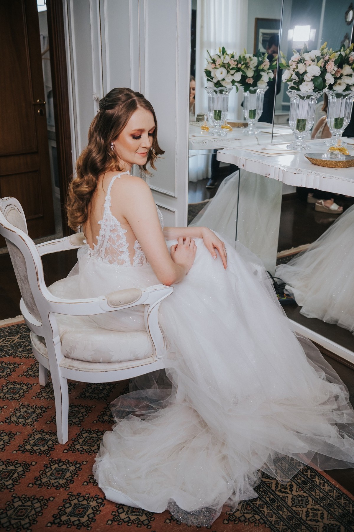 A noiva pronta sentada em frente ao espelho