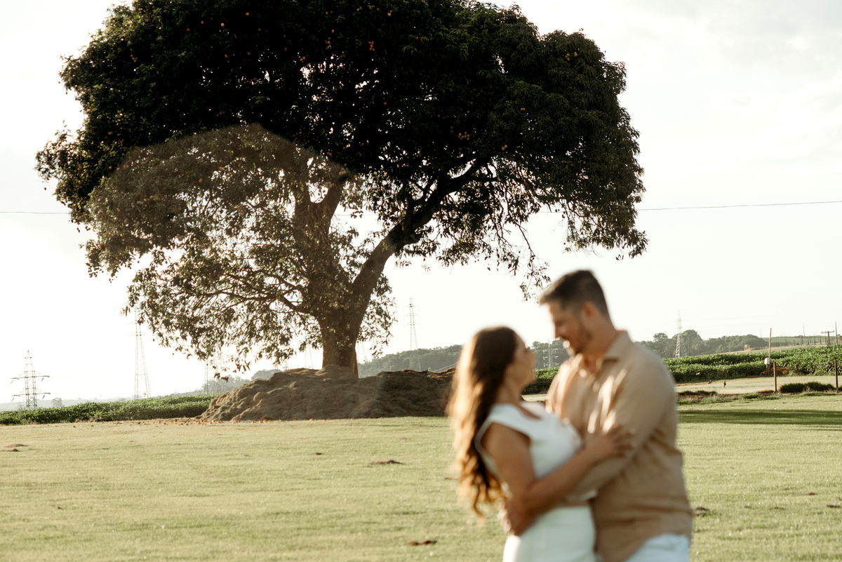 Foto do casal em primeiro plano desfocado e o segundo plano focado