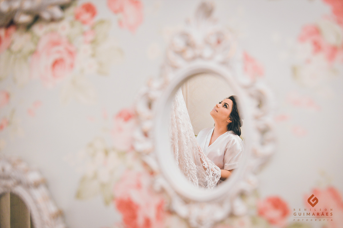 A noiva Alessandra olhando o seu vestido de noiva