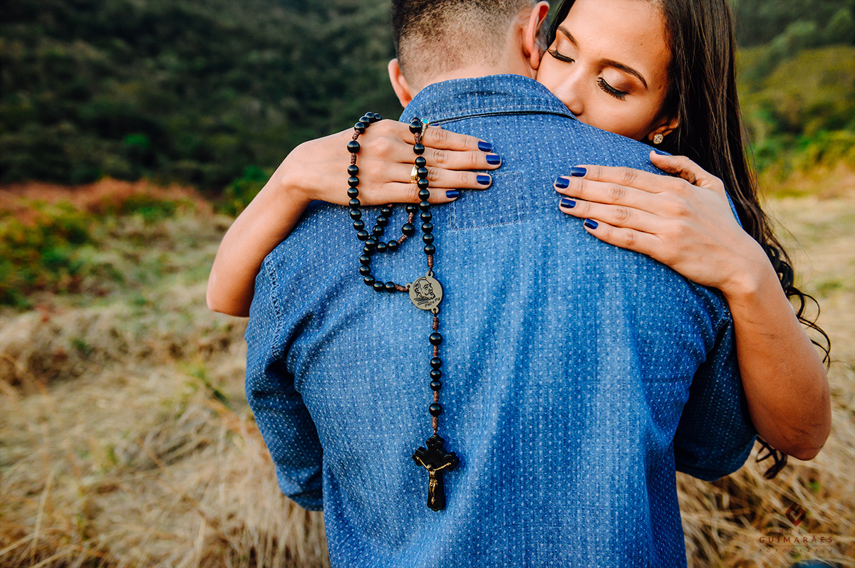 A noiva segurando um rosário no ensaio pré-wedding