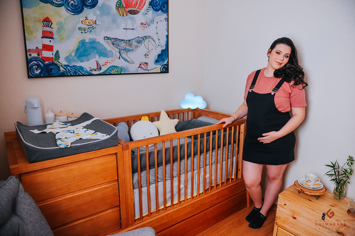 Foto da gestante no quartinho do bebê