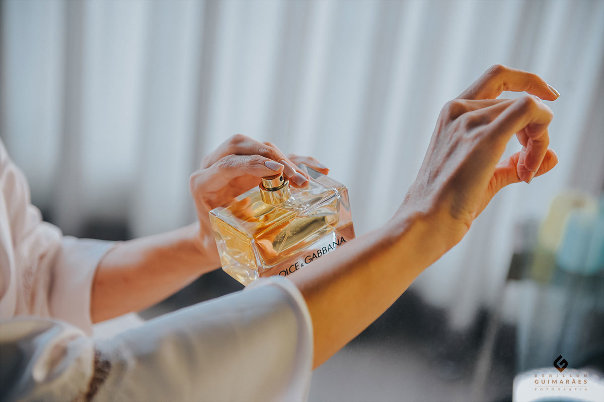 Gesto delicado da noiva passando o perfume