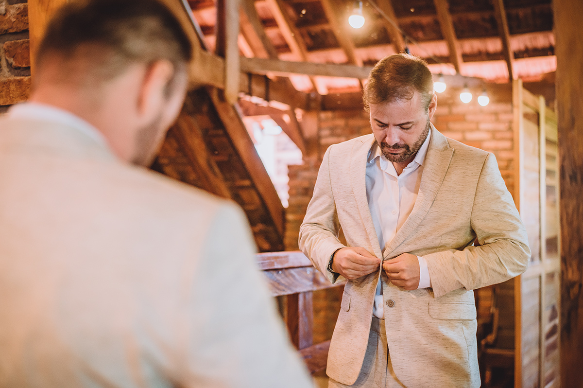 O noivo abotoando o terno