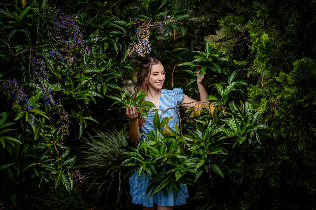 Elegant quinceañera portrait surrounded by the beautiful gardens of Museo El Castillo.