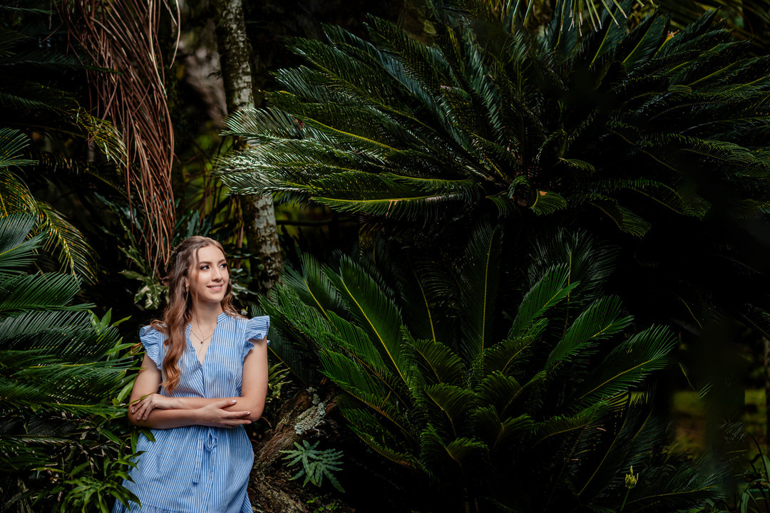 Elegant quinceañera portrait surrounded by the beautiful gardens of Museo El Castillo.