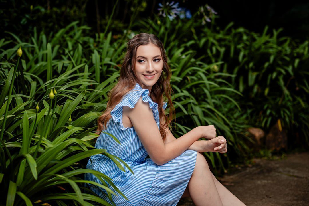 Elegant quinceañera portrait surrounded by the beautiful gardens of Museo El Castillo.