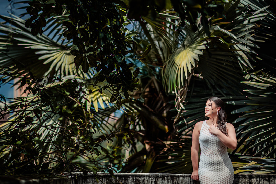 Elegant quinceañera portrait surrounded by the beautiful gardens of Museo El Castillo.