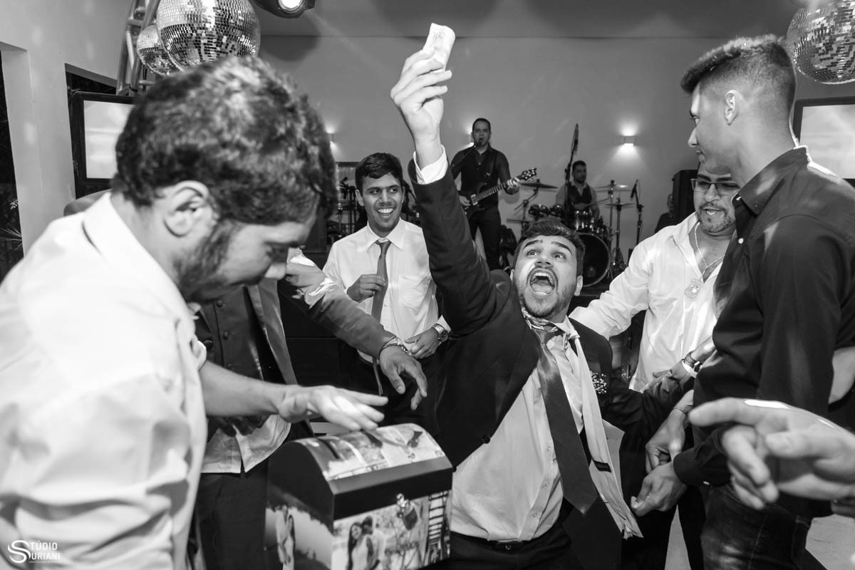 Padrinhos dando muito dinheiro para o noiva durante a gravata 