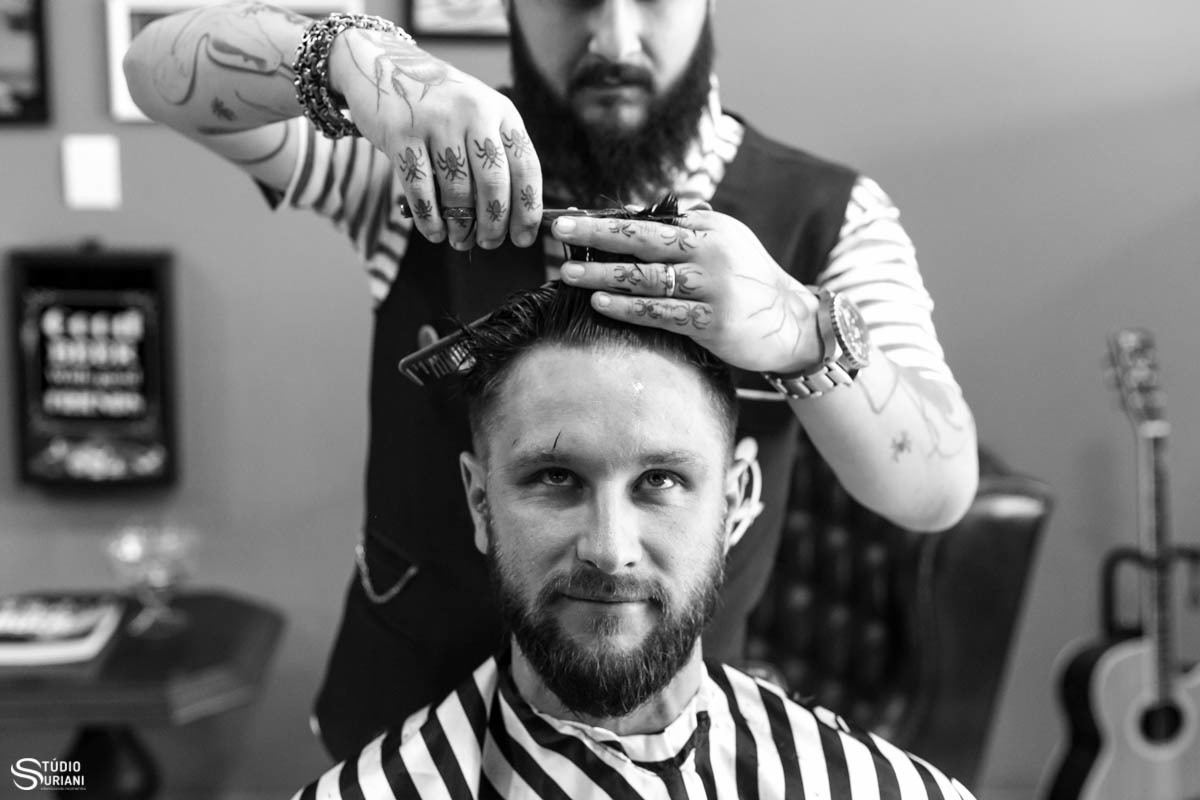 Foto engraçada do noivo cortando o cabelo para o casamento na barbearia