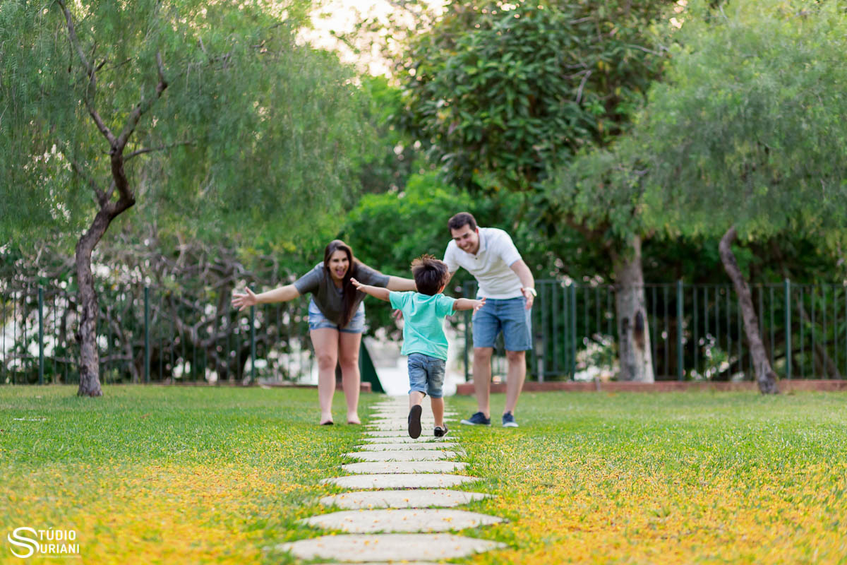 Filho correndo em direção aos pais brincando de abraço 