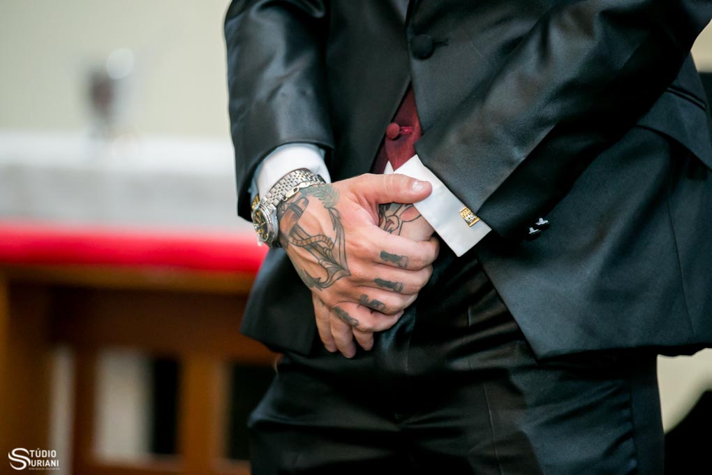 noivo tatuado se casamento na igreja com terno armani na cor vinho