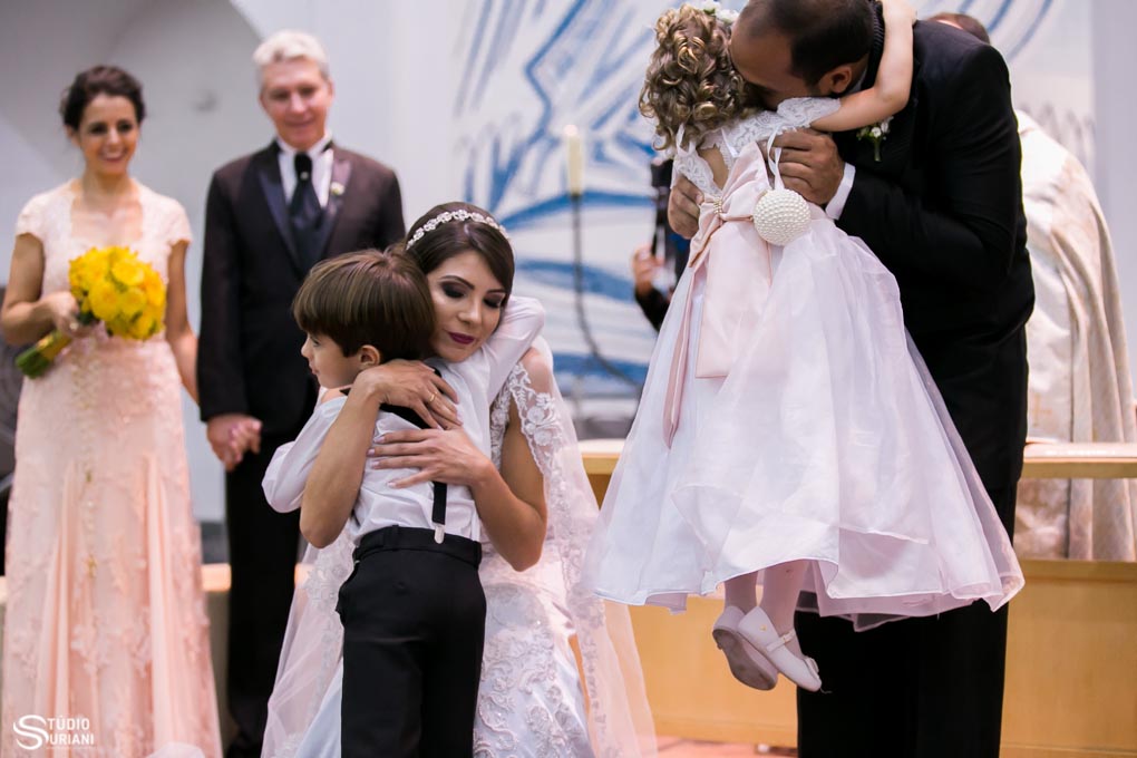 pages abraçando os noivos na hora de entregar aliança