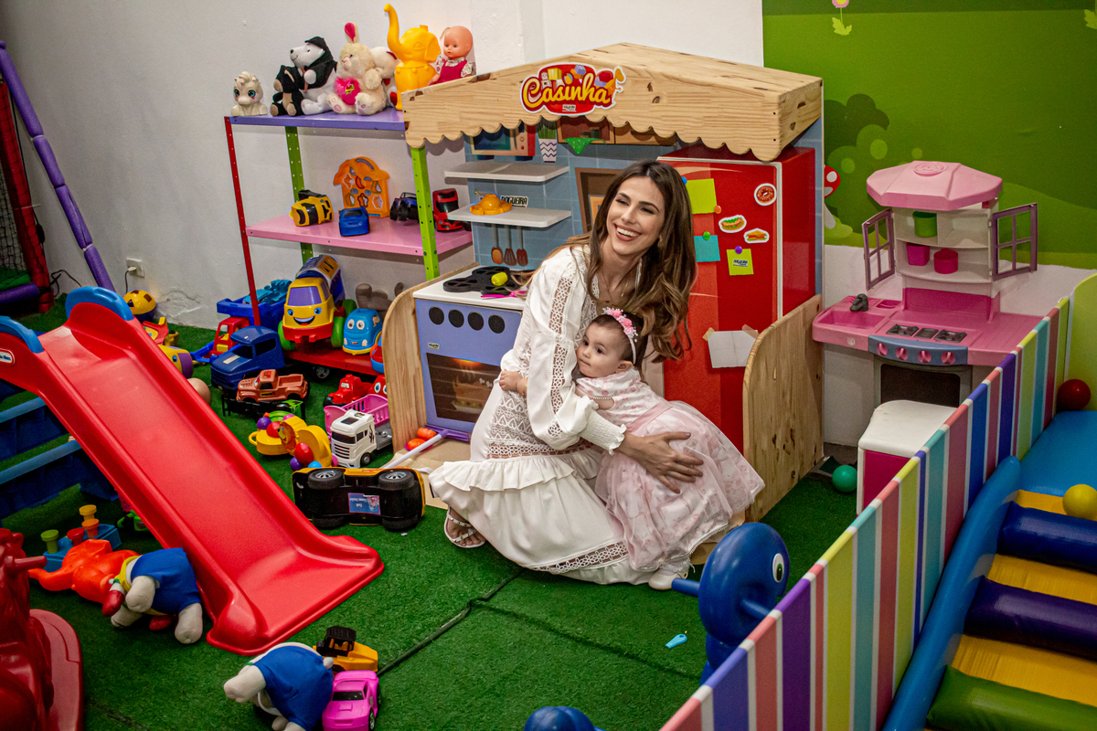 mae brincado com a filha em festa infantil