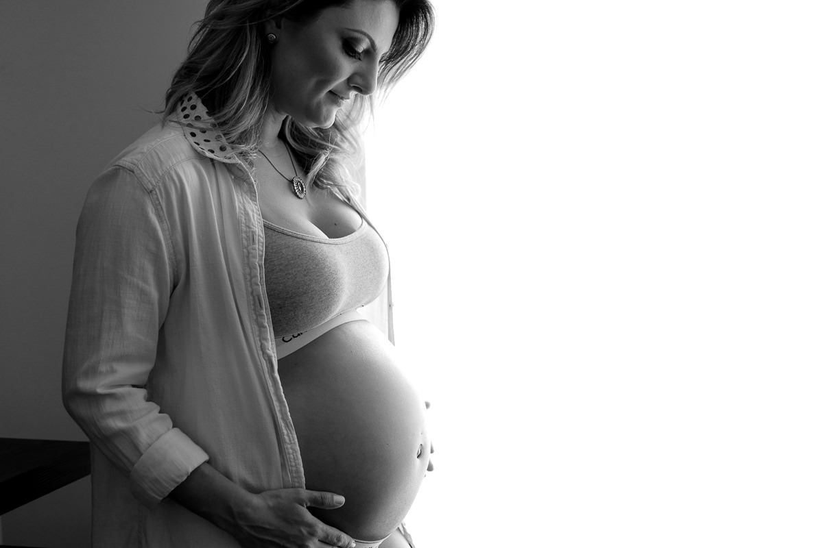 ensaio gestante na sala de casa de lingerie